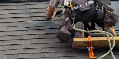 Project Pros Professional roofing contractor installing asphalt shingles on a residential roof