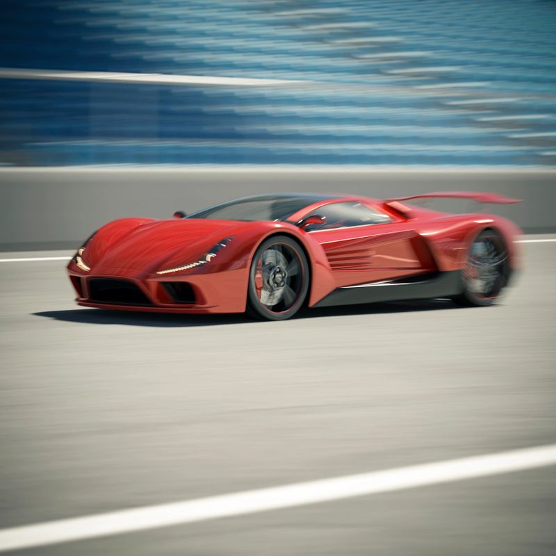 A red sports car on a race track. Strong motion and camera blur with focus on the front wheel.  The car and the entire scene are designed and modelled by myself. Very high resolution 3D render composite. All markings are ficticious.
