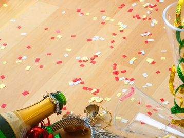 Celebration aftermath with confetti, champagne, and party decorations.