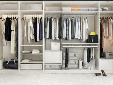 Organized modern wardrobe with neatly hung clothes and storage boxes.