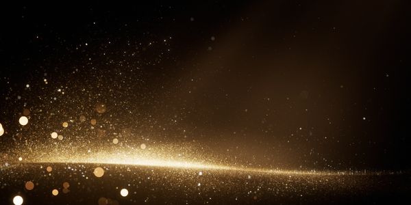 Golden bokeh particles glowing against a dark background.