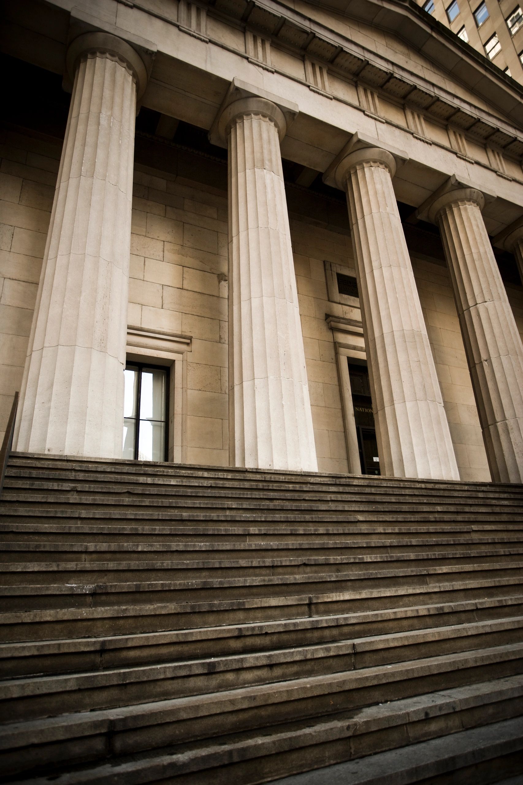 Grand stone steps leading to tall classical columns of a historic building.