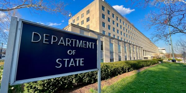 Department of State building exterior with sign.