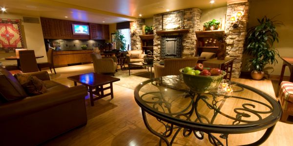 Cozy living room with stone fireplace and glass table.