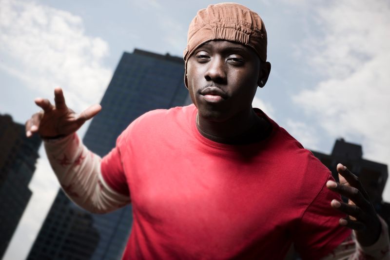 African American rap artist gets up close and personal with the camera. New York City behind him. CLICK FOR SIMILAR IMAGES AND LIGHTBOXES WITH MORE MEN OR ETHNIC FACES.