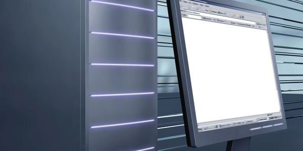 Close-up of a computer server and monitor in a tech environment.