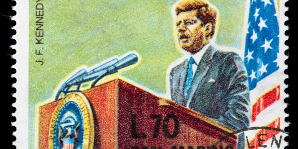 Stamp featuring John F. Kennedy giving a speech.
