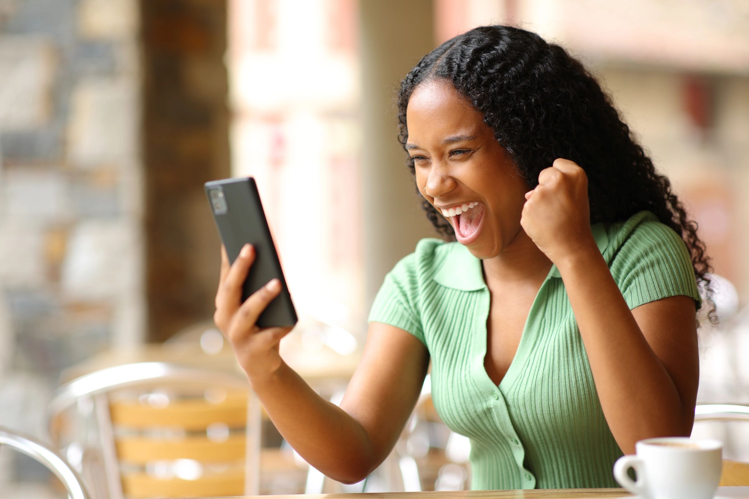 Woman laughing with Hold mobile on hand with looking on the Mobile screen