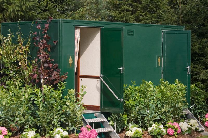 "A luxury, mobile ladies and gentlemenaas toilet at an outdoor event."