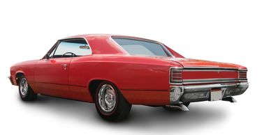 Classic red vintage muscle car with chrome details and dual exhausts.