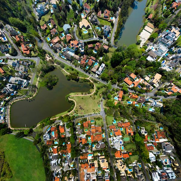 Aerial view of a residential neighborhood with lakes and green spaces.