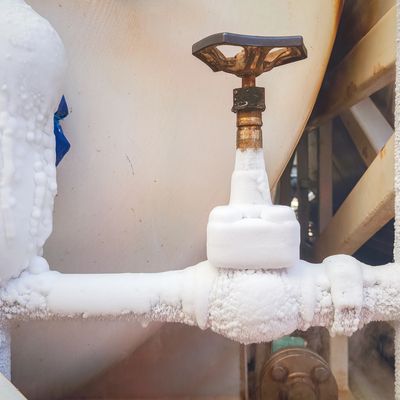 Frozen valve and pipe covered in ice.