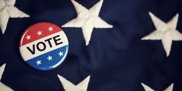 Vote button on American flag.