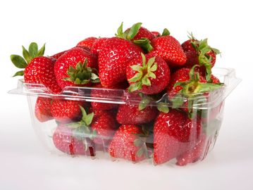Fresh strawberries packed in a clear plastic container.