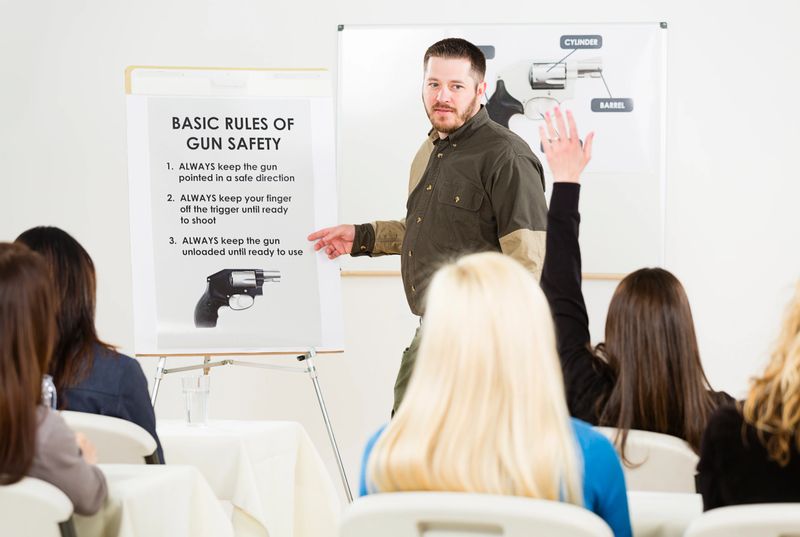 An instructor teaching a gun safety class to a group of students.