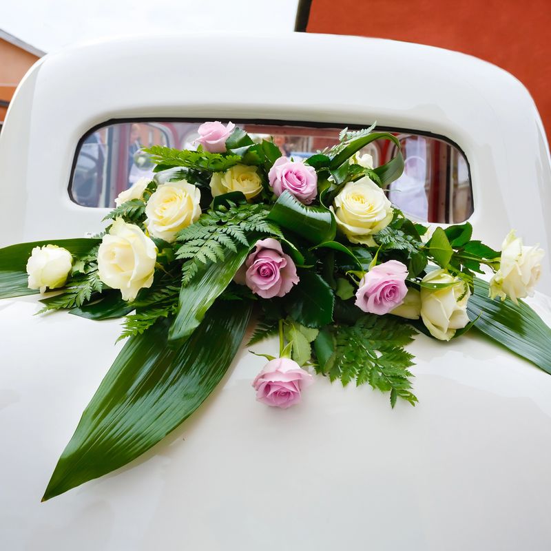 Luxury wedding white car decorated with roses