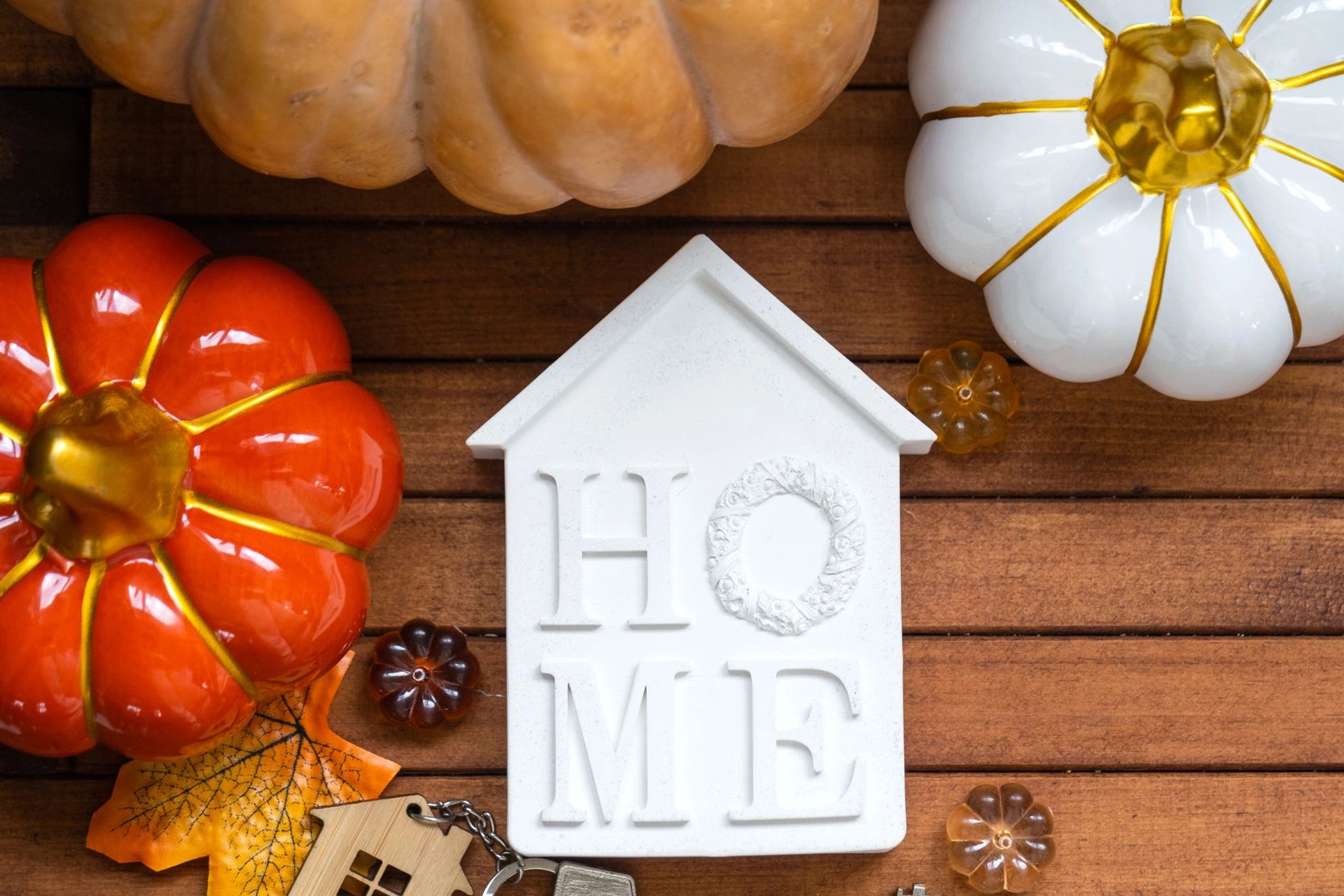 Autumn-themed home decor with pumpkins and a HOME sign.