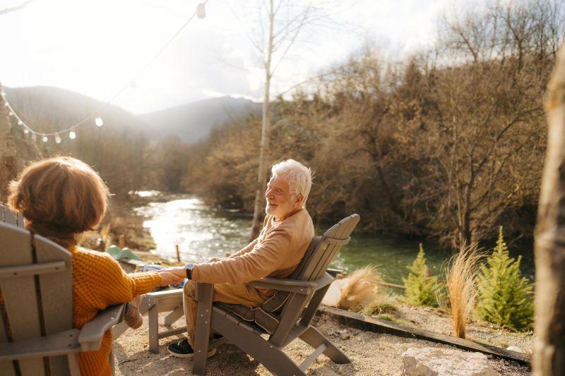 An inviting retirement lifestyle setting with cozy outdoor seating and lush landscaping.