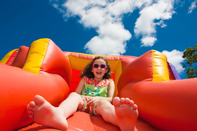 girl sliding down on a bouncy castle