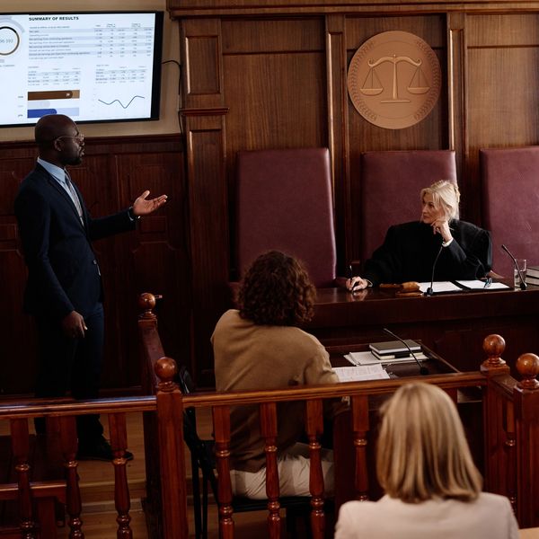 Courtroom setting with an attorney presenting to the jury using trial technician solutions