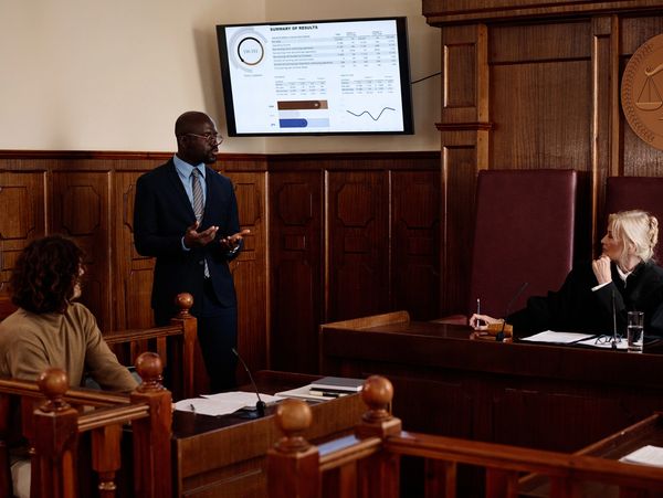 Lawyer presenting data to judge in courtroom.