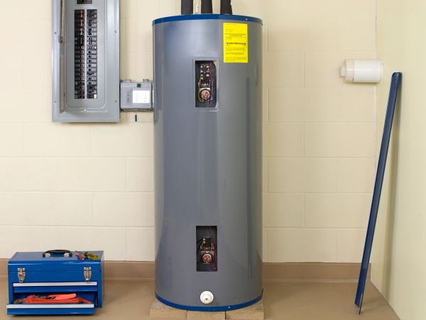 A gray water heater in a utility room.