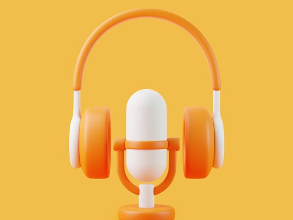 Orange and white headphones surrounding a white and orange microphone on yellow background.