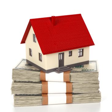House model on stacks of cash.