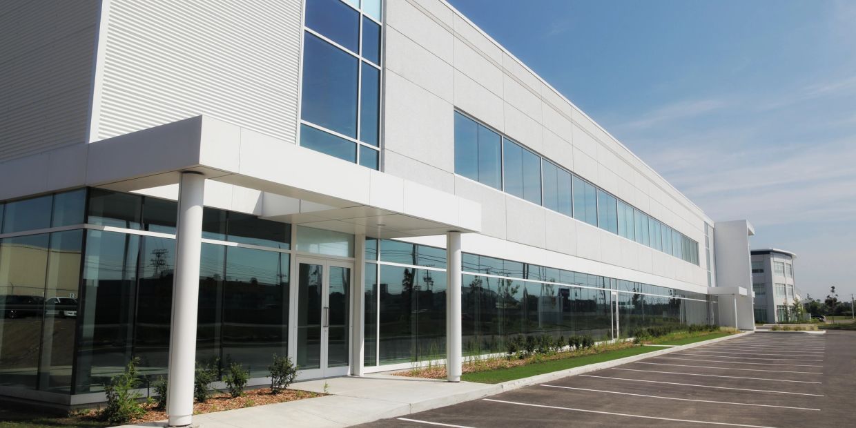 Modern commercial office building with large windows.