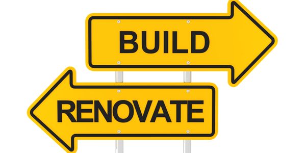 arrow shaped signs with black font saying build pointing one direction, renovate pointing the other