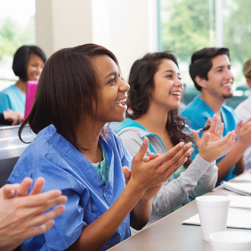 Happy students in nursing or medical school college classroom.