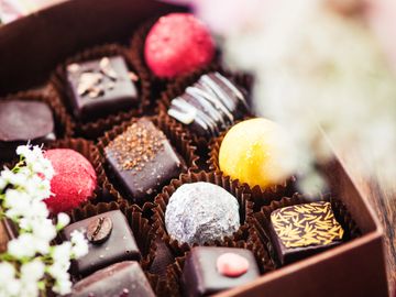Assorted gourmet chocolates and truffles in a gift box.