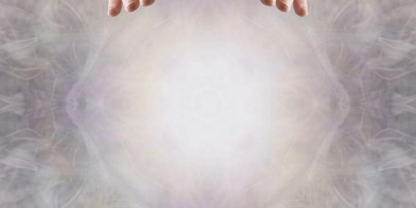 Hands reaching towards a bright, mystical light surrounded by swirling mist.