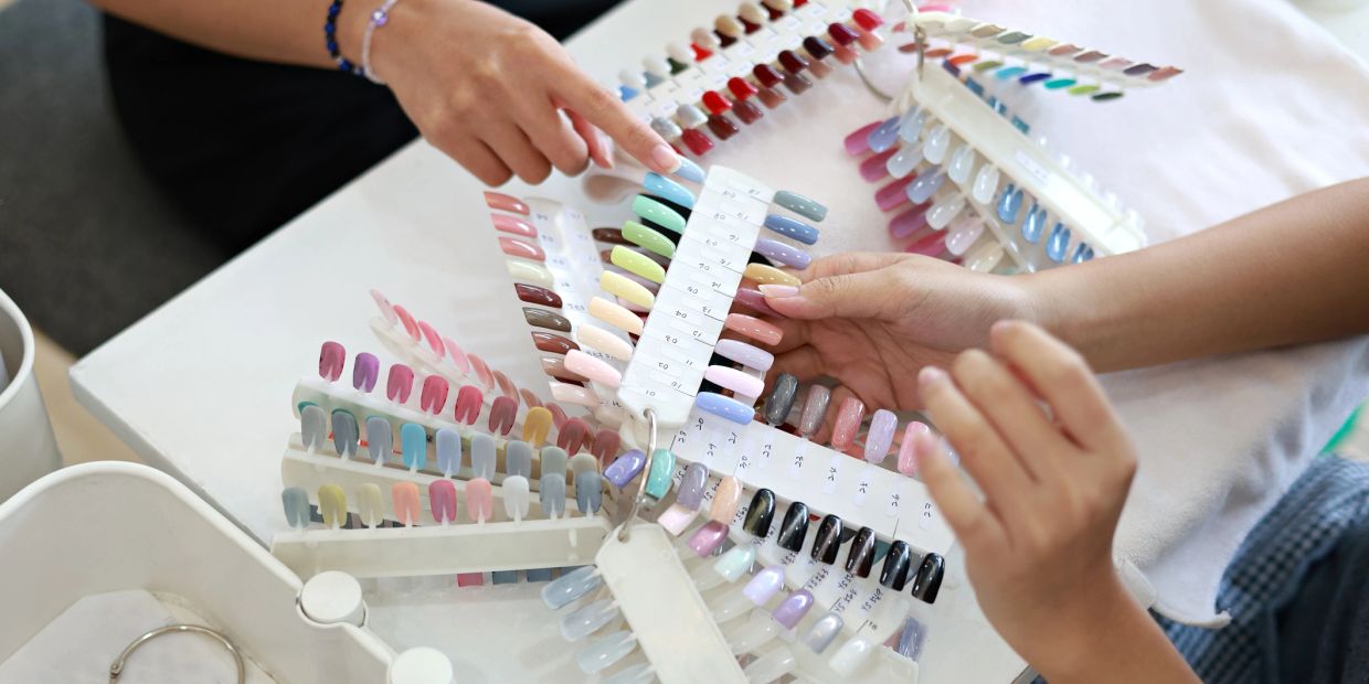 Elegant hands with perfect French manicure in a serene spa environment.