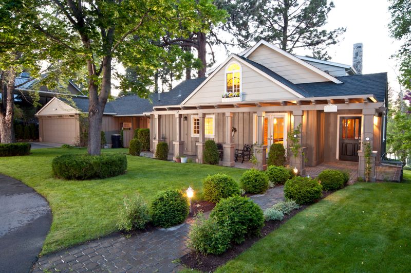 This twilight exterior of the home has beautiful manicured lawns.