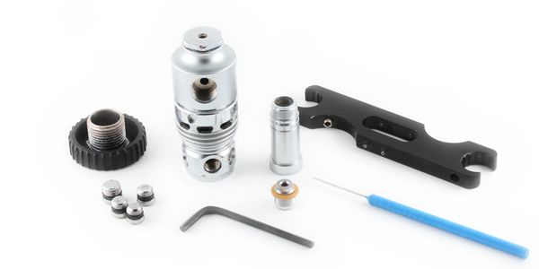 Disassembled metal and plastic mechanical parts with a blue tool on white background.