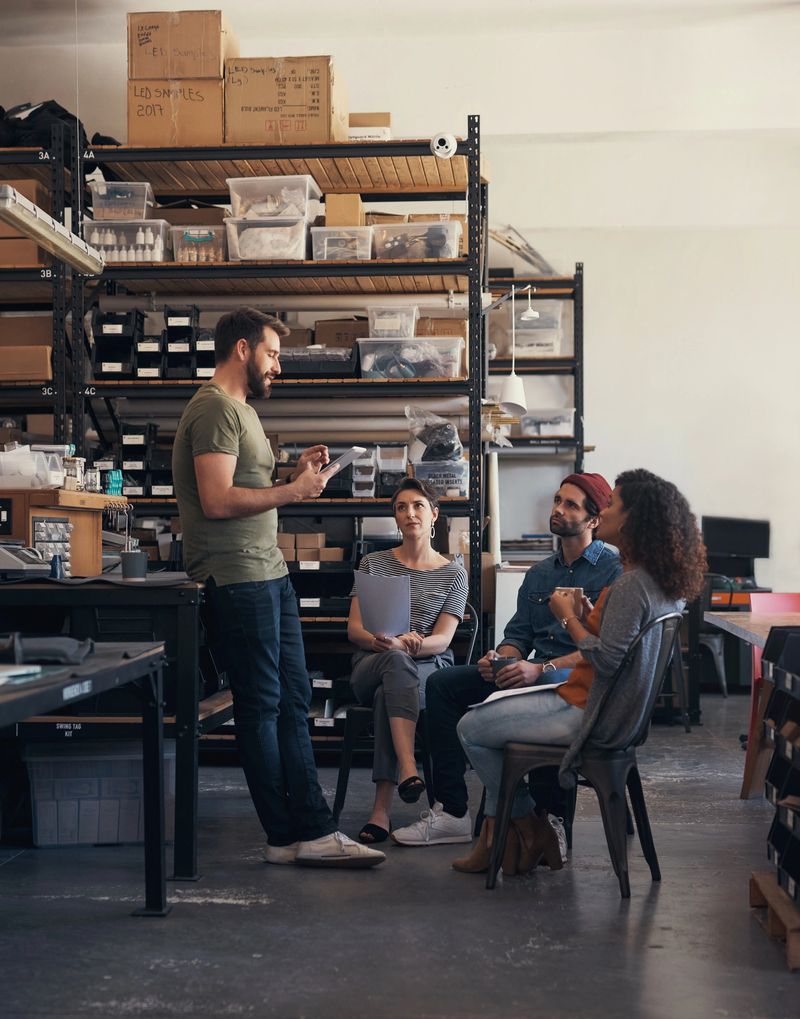 Team meeting, boss and tablet in workshop for supply chain, startup and factory project. Warehouse, discussion and manager for company, business and operations for report, online and collaboration