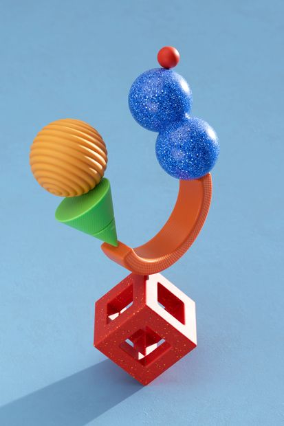 Colorful abstract geometric sculpture with spheres, cones, and cubes on a blue background.