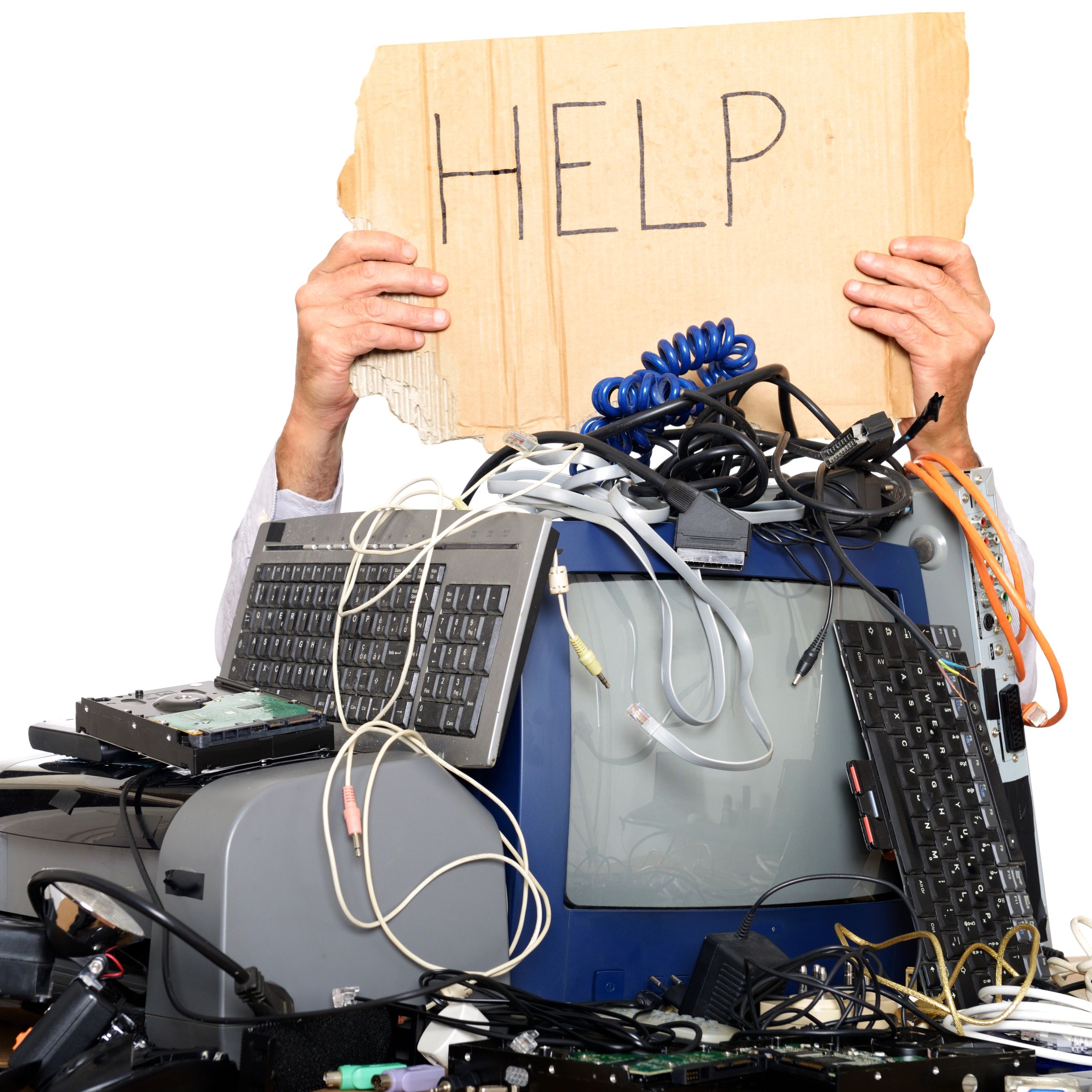 A pile of entangled computer equipment with a sign being held above it saying "HELP".