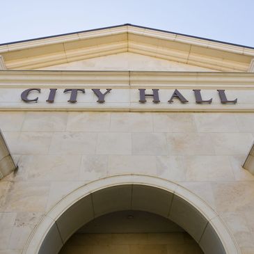 Close-up view of a City Hall building entrance with an arch.