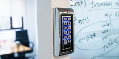 Electronic keypad door lock on a wall.