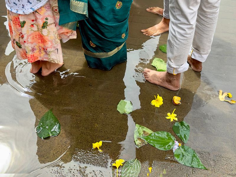 Low section shot of Hindu worshipers during religious rituals