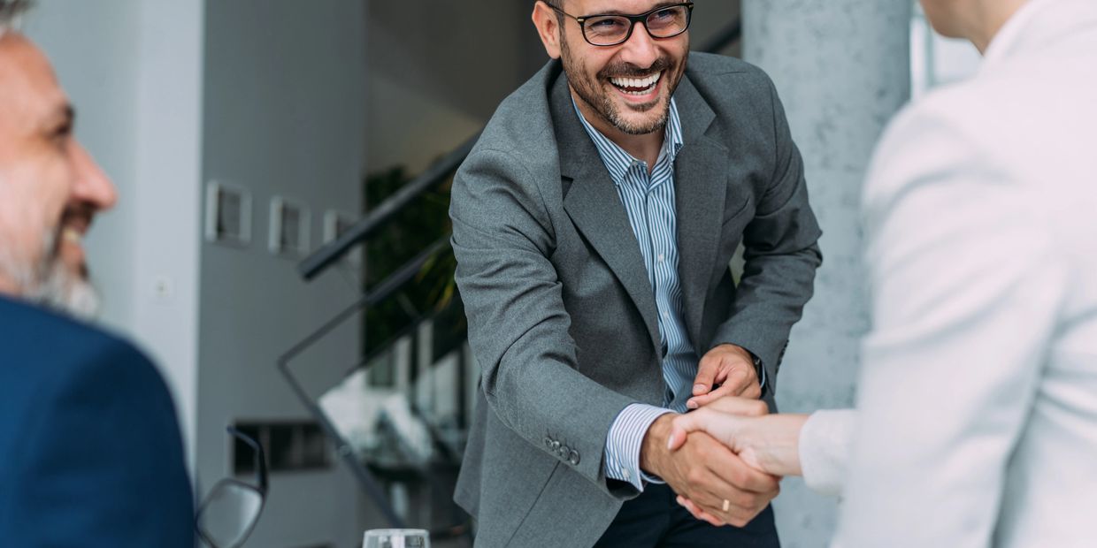 Businessmen shaking hands during a meeting.