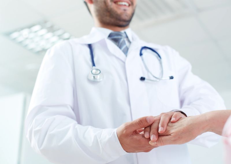 Image of doctor and senior patient hands