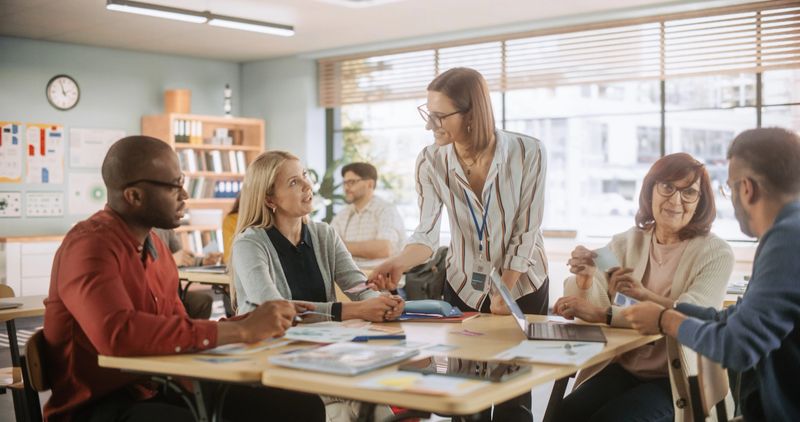 Diverse Group of Multiethnic Young and Senior Adults Finding a Solution to a Team Assignment, Undergoing Workforce Training Program for Improving Skills of Employees and Prospective Job Applicants.