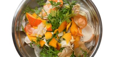 Bowl of mixed vegetable and herb scraps.