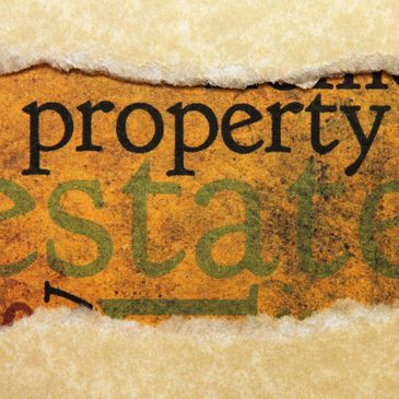 Torn paper revealing the words 'property' and 'estate'.
