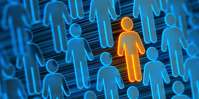 Orange figure stands out among blue figures in a digital crowd.