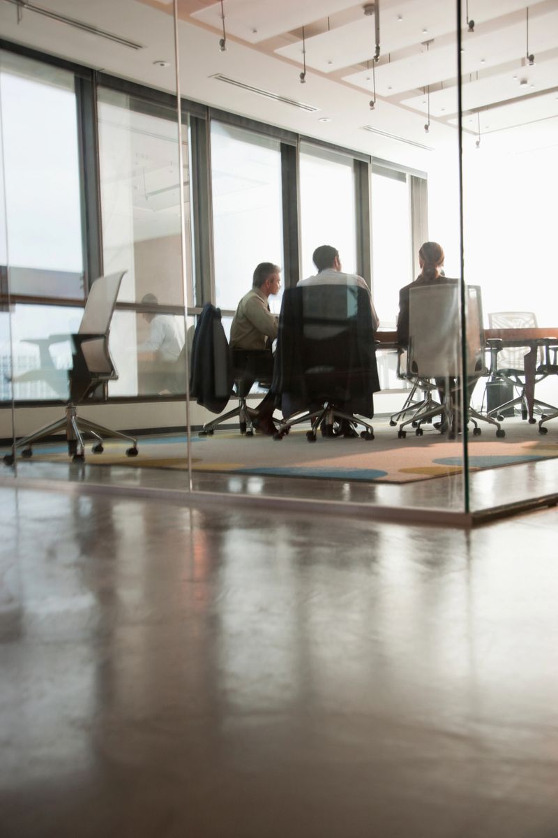 Four businesspeople sitting at a boardroom table