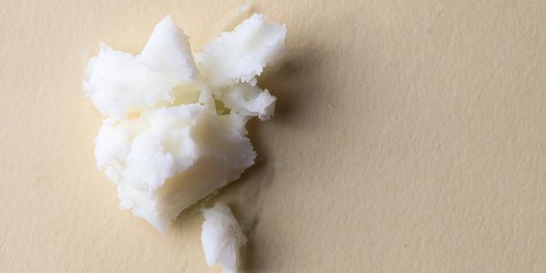 Close-up of white solid chunks on a beige surface.